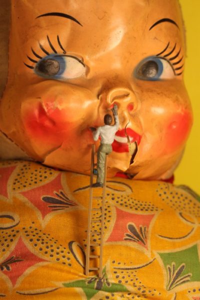 workman_restores_doll_face